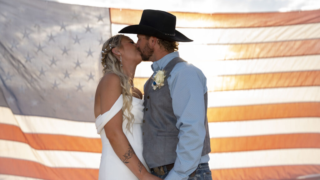Kenzie and Dane kiss during their country wedding in Alamo Nevada