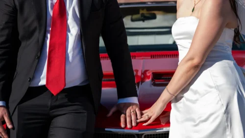 Newlyweds in a red 1970 Buick GS convertible at Red Rock Canyon, Las Vegas wedding
