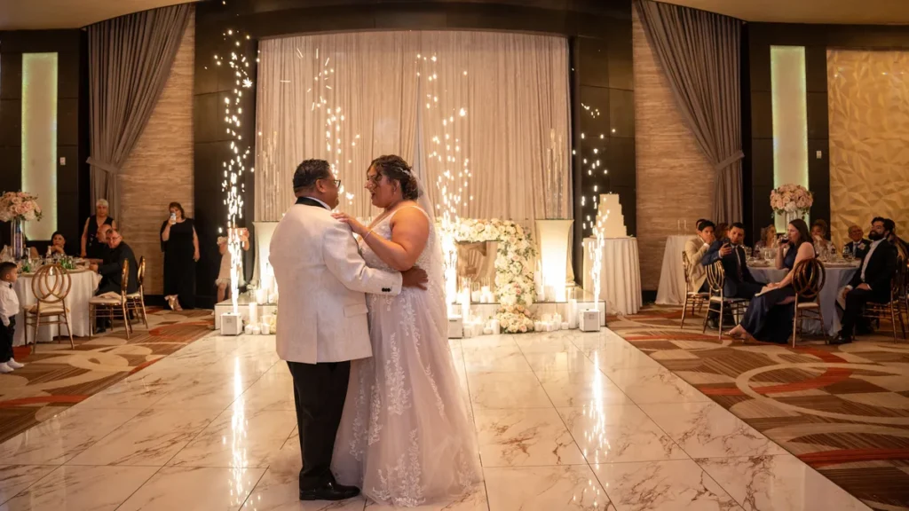 Armine and Carlos first dance beneath sparkler lights backdrop at Fabrizio Banquet Hall wedding